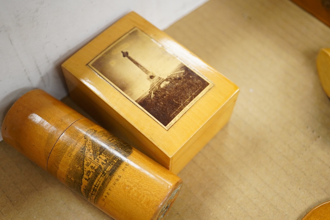 A collection of Scottish mauchline ware boxes, a pin cushion, beaker and a photo frame containing black and white topographical photos